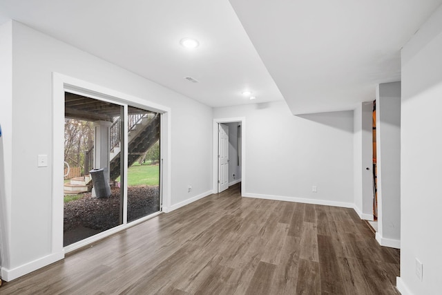 interior space with visible vents, stairs, wood finished floors, baseboards, and recessed lighting