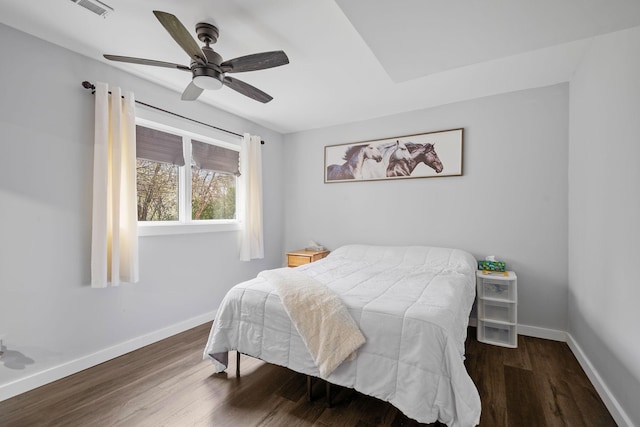 bedroom with ceiling fan, baseboards, visible vents, and wood finished floors