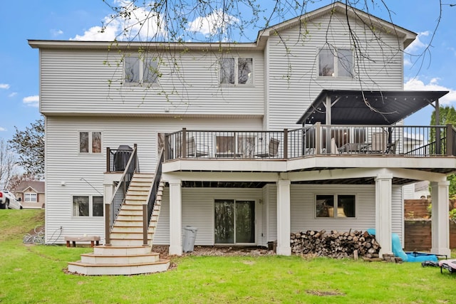 back of house featuring a lawn, a wooden deck, and stairs