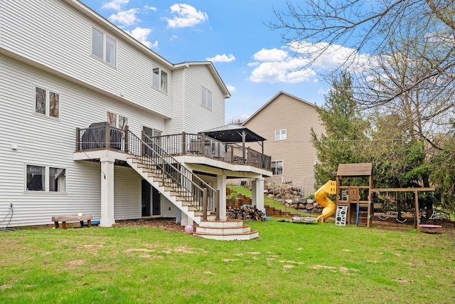 back of house with a deck, stairs, a playground, a gazebo, and a yard