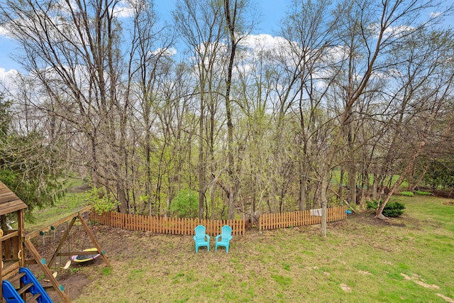 view of yard with a playground and fence