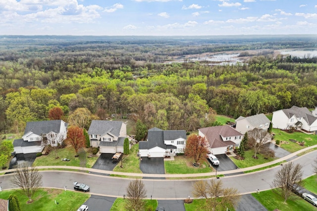 drone / aerial view with a residential view and a wooded view