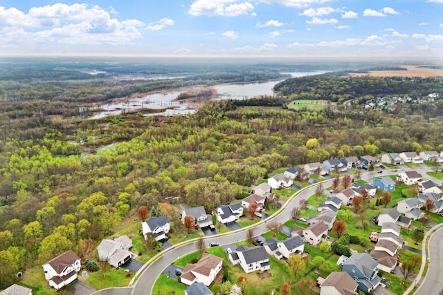 aerial view featuring a water view, a residential view, and a forest view