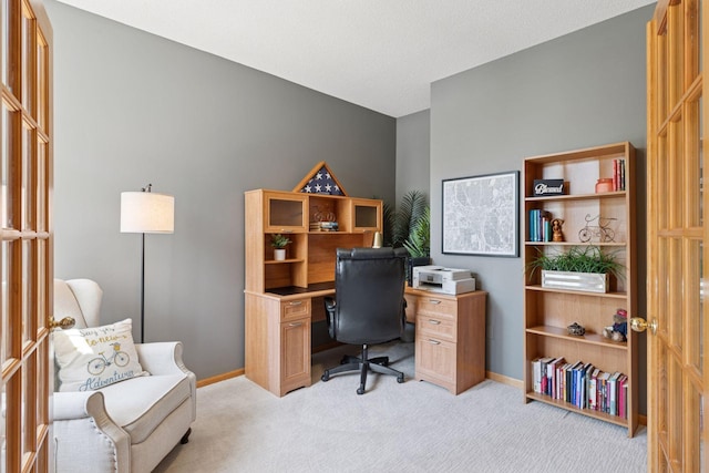 office area with light carpet and baseboards