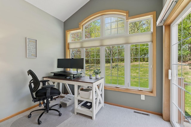 carpeted office space with lofted ceiling, baseboards, and healthy amount of natural light