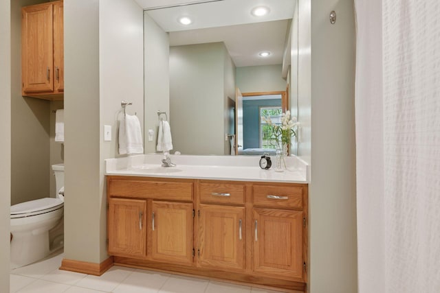 bathroom featuring toilet, vanity, and tile patterned floors