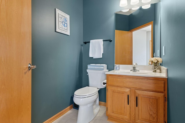 bathroom with tile patterned flooring, toilet, baseboards, and vanity