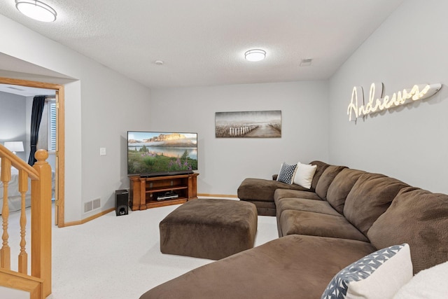 carpeted living area featuring baseboards, a textured ceiling, and stairs