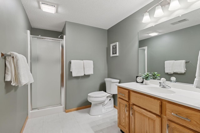 bathroom featuring a stall shower, toilet, baseboards, a textured ceiling, and vanity