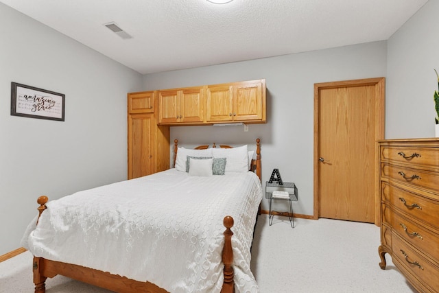 bedroom with light colored carpet and baseboards