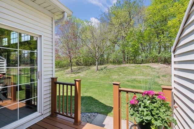 wooden terrace with a lawn