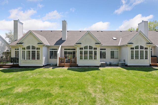 rear view of house featuring a deck, central AC, and a yard