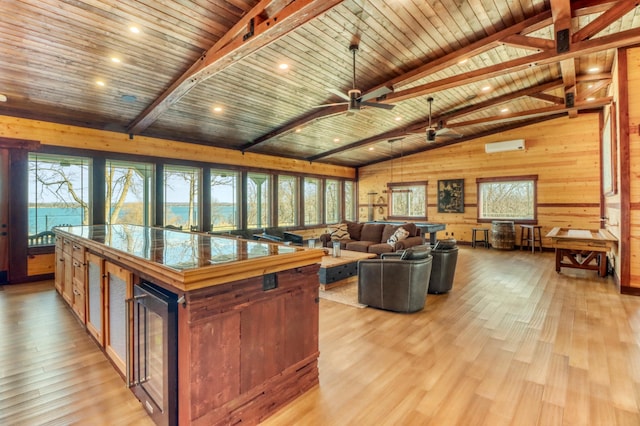 23351 County Highway 22, Lake View Twp, MN 56501 - living area featuring wood walls, wine cooler, plenty of natural light, wood ceiling, and lofted ceiling with beams