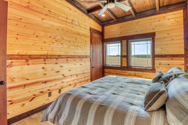 23351 County Highway 22, Lake View Twp, MN 56501 - bedroom with wood walls, wood finished floors, beamed ceiling, ceiling fan, and wood ceiling