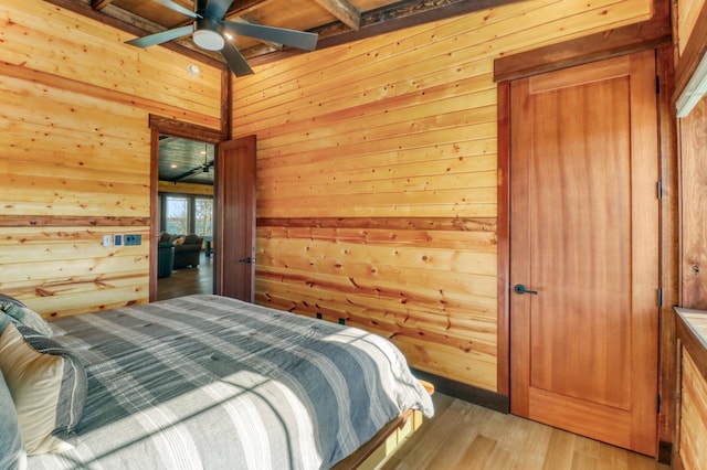 23351 County Highway 22, Lake View Twp, MN 56501 - bedroom with wooden walls, light wood-type flooring, and beam ceiling