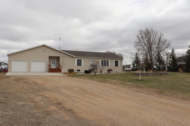 single story home featuring a garage, dirt driveway, entry steps, and a front lawn