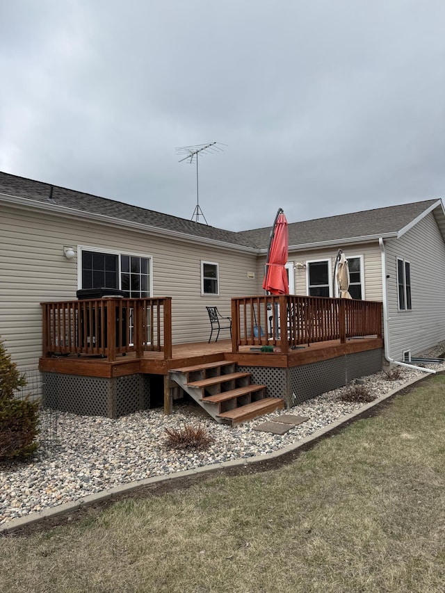 back of house with a lawn and a deck