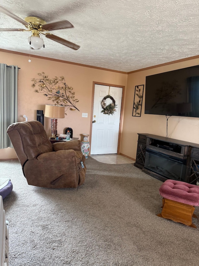 carpeted living room with a ceiling fan, a textured ceiling, and ornamental molding
