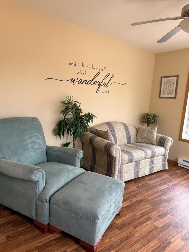 living area featuring ceiling fan and wood finished floors