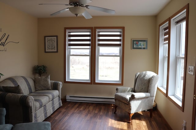 sitting room featuring ceiling fan, baseboard heating, and dark wood-style floors