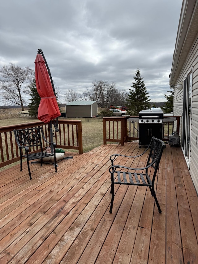 wooden deck featuring an outdoor structure and grilling area