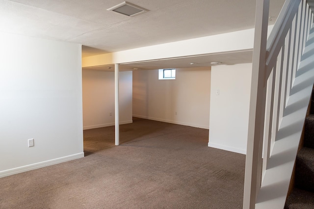 basement with baseboards, carpet, and stairway