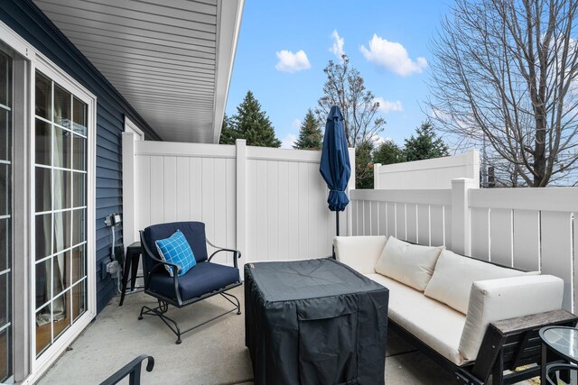 view of patio featuring an outdoor hangout area and fence
