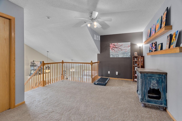 interior space featuring carpet floors, a textured ceiling, ceiling fan, and baseboards