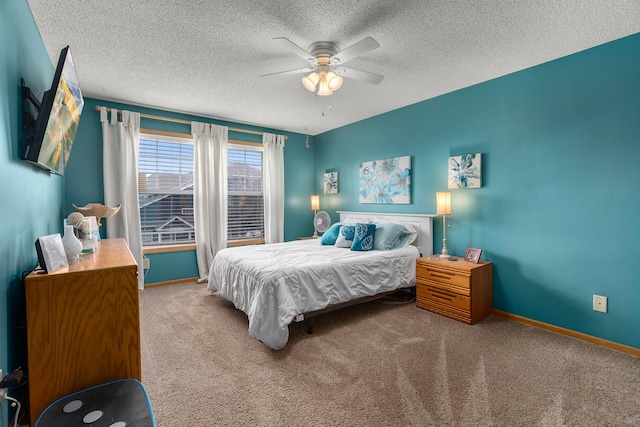 carpeted bedroom featuring a ceiling fan, a textured ceiling, and baseboards