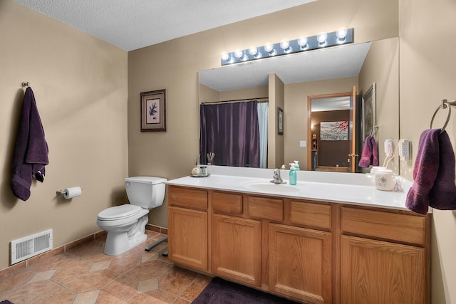 full bathroom featuring a textured ceiling, visible vents, vanity, baseboards, and toilet