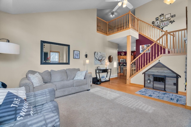 428 Hickory Ln N, Oakdale, MN 55128 - living area featuring stairway, a ceiling fan, carpet, high vaulted ceiling, and wood finished floors