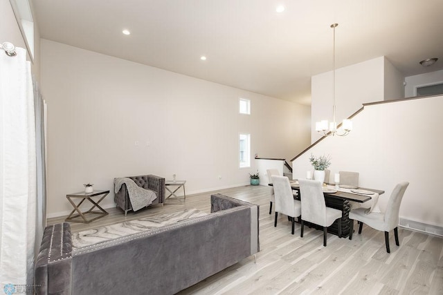 living room featuring a chandelier, stairs, recessed lighting, baseboards, and light wood-type flooring