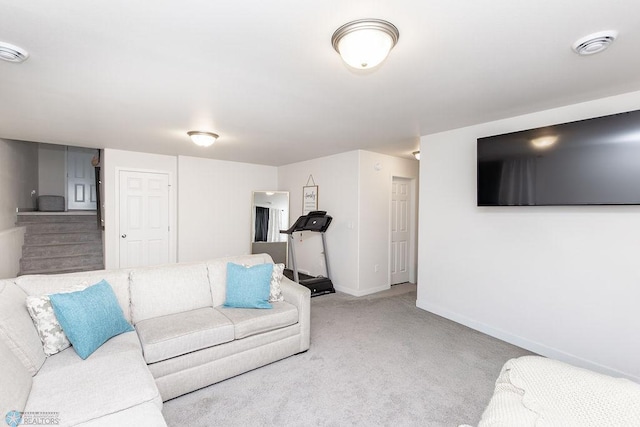 carpeted living area with baseboards and visible vents