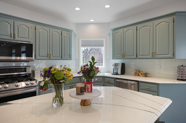 kitchen with recessed lighting, appliances with stainless steel finishes, and backsplash