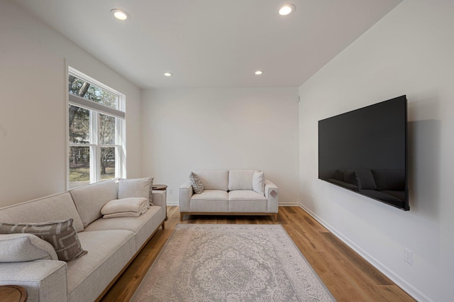 living room with recessed lighting, baseboards, and wood finished floors