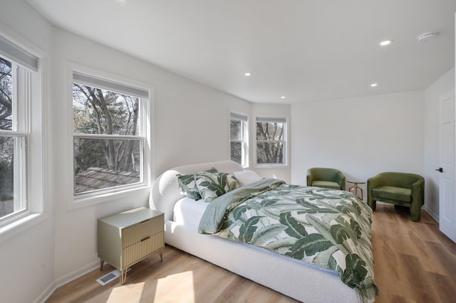 bedroom with recessed lighting, baseboards, and wood finished floors