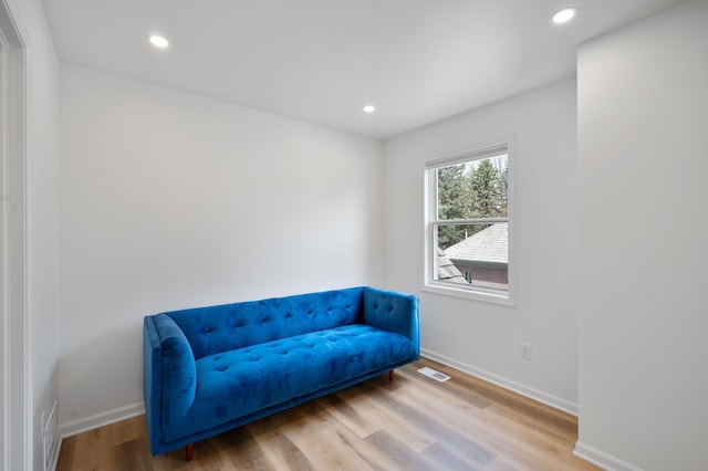 sitting room with baseboards, recessed lighting, wood finished floors, and visible vents