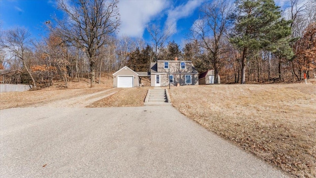view of front of property with driveway and a detached garage