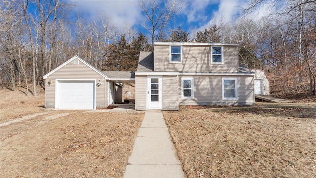 view of front of house featuring an attached garage and roof with shingles