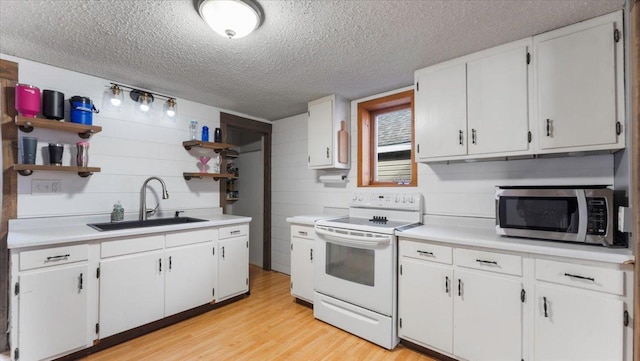 kitchen featuring open shelves, white electric range, stainless steel microwave, a sink, and a textured ceiling