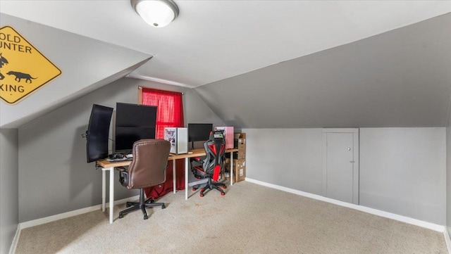 office space with vaulted ceiling, carpet floors, and baseboards