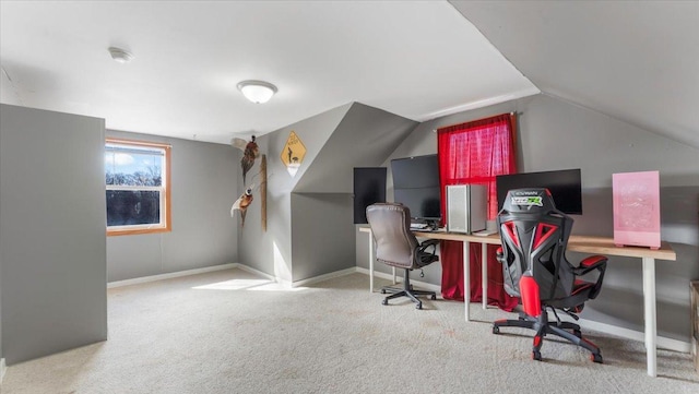 office area with carpet flooring, lofted ceiling, and baseboards