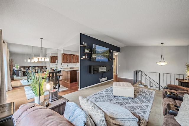 3903 Gershwin Ave N, Oakdale, MN 55128 - living area featuring visible vents, lofted ceiling, and light wood-style floors