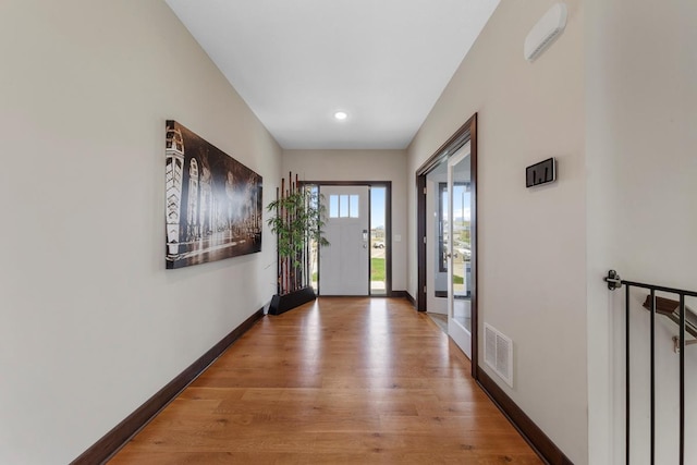 2120 Violet Ln, Faribault, MN 55021 - doorway to outside with visible vents, light wood-style floors, and baseboards