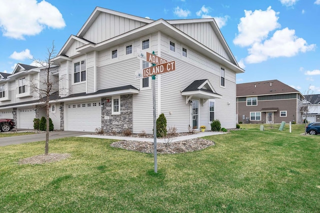 2166 Island Ct, Lino Lakes, MN 55038 - townhome / multi-family property featuring board and batten siding, a front yard, a garage, and asphalt driveway