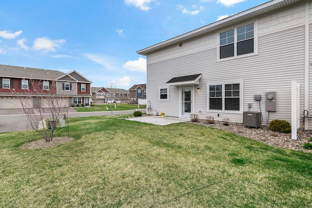 2166 Island Ct, Lino Lakes, MN 55038 - rear view of house featuring central AC, a lawn, a residential view, and a patio