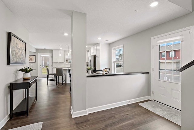 2166 Island Ct, Lino Lakes, MN 55038 - kitchen with white cabinets, dark wood-type flooring, freestanding refrigerator, baseboards, and recessed lighting