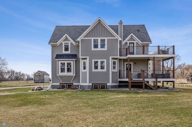 rear view of property featuring a shingled roof, board and batten siding, a chimney, a balcony, and a lawn