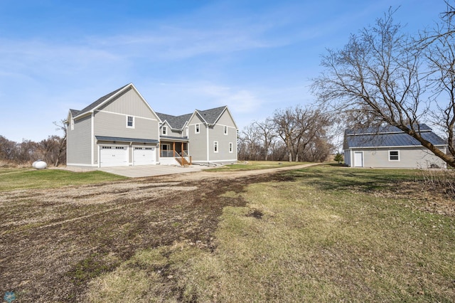 exterior space with an attached garage, a yard, and driveway