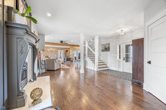 entrance foyer with ceiling fan, stairs, wood finished floors, ornate columns, and recessed lighting
